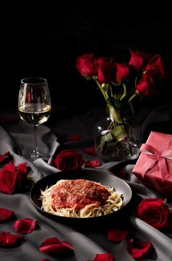 Μακαρόνια με κιμά σε ρομαντικό δείπνο με λουλούδια και κρασί